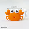 An orange ocean animal cake topper set featuring a whale, octopus, and turtle.