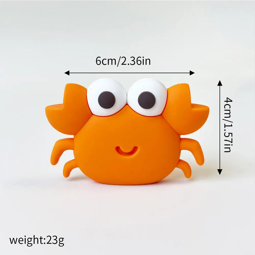 An orange ocean animal cake topper set featuring a whale, octopus, and turtle.