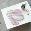 Pink and white cat-themed food bag squeezer tools displayed on a white table.