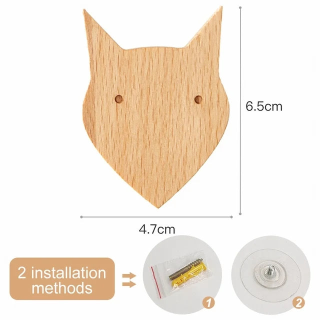 A light wood decorative animal hook shaped like a fox head, shown with installation methods.