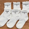 A set of white socks for a bridal party, including bride and bridesmaid styles with delicate lace trim.