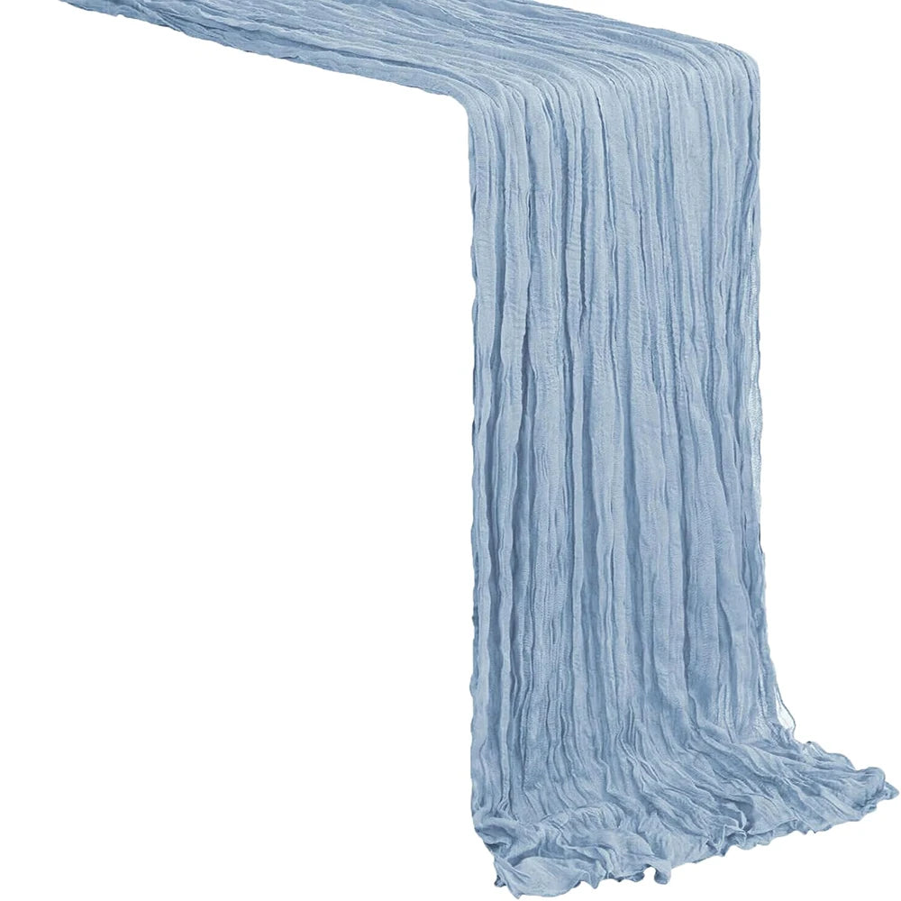 A light blue semi-sheer gauze table runner draped in vertical folds.