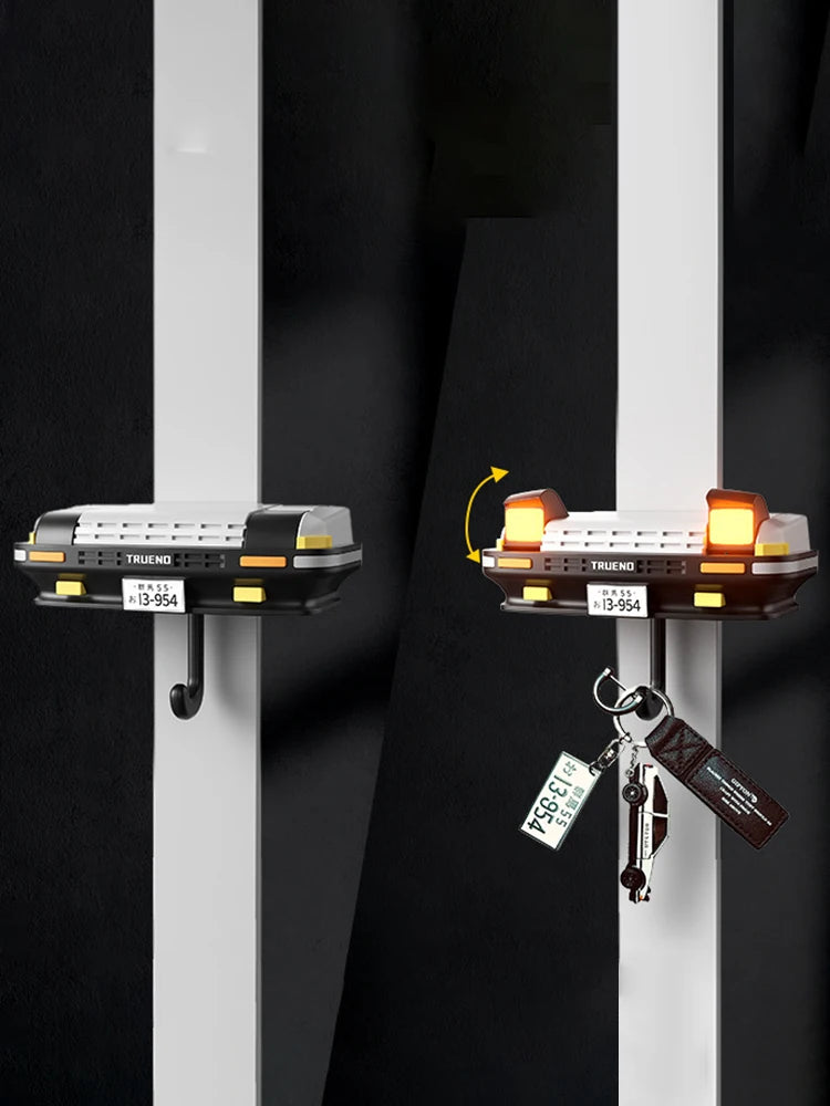 A classic car headlight key holder with LED illumination is displayed against a dark background.