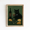 A framed canvas art print featuring a black cat sitting on a green surface next to a bottle of wine and cheese.