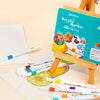A set of acrylic markers is displayed on a wooden easel with various colored markers and art materials.