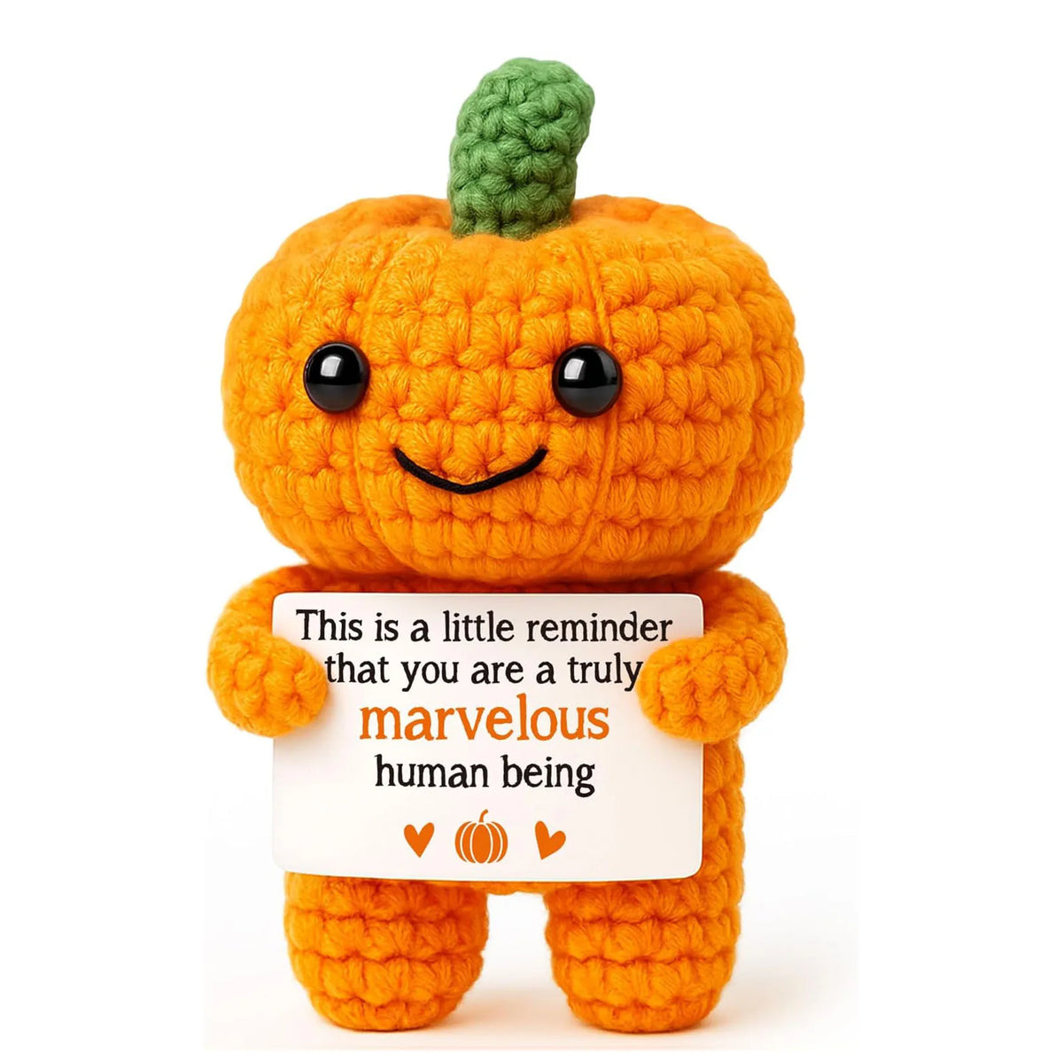 Handmade crochet orange pumpkin with a green stem and black eyes, featuring a message about being marvelous.