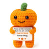 Handmade orange crochet donkey figurine with a green tuft and an inspirational card