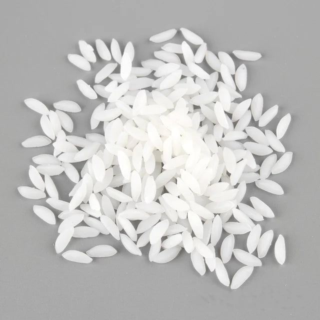 A pile of realistic white resin fake corn miniatures for crafting and décor.