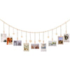 A string of light pink heart-shaped garlands displaying various framed photos.