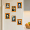 A collection of five framed prints featuring cute ghost Halloween themes displayed on a white refrigerator.