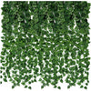 A dense green artificial ivy leaf garland covering a surface for indoor or outdoor decoration.