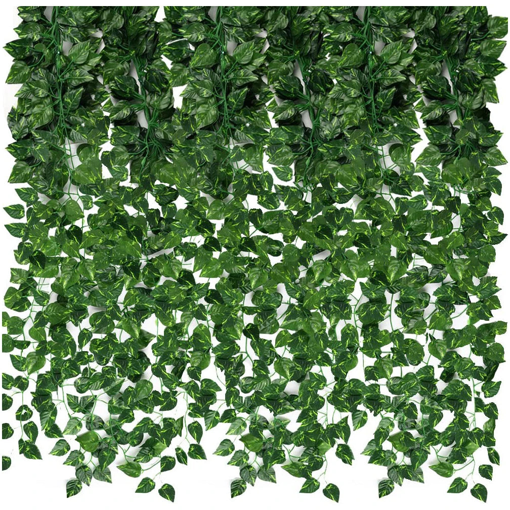 A dense green artificial ivy leaf garland covering a surface for indoor or outdoor decoration.
