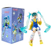 A PVC collectible figurine of Hatsune Miku in a yellow and blue outfit with long teal hair and wings.