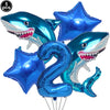 A set of five blue shark foil balloons, including a number two balloon, for an ocean-themed party decoration.