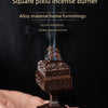 A square pixiu incense burner made of alloy material is being held in a hand, emitting smoke.