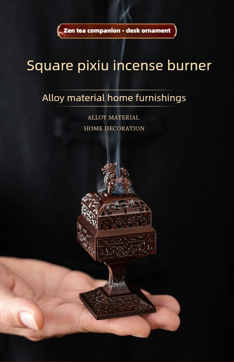 A square pixiu incense burner made of alloy material is being held in a hand, emitting smoke.