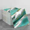 A stack of self-adhesive marble tile stickers featuring teal and white marble patterns with gold veining.
