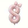 Large pink foil number balloon shaped like the number 8 with a bow