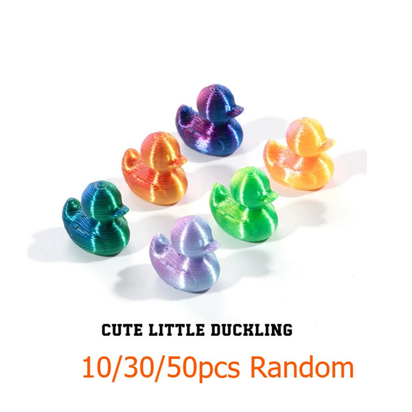 A collection of ten colorful 3D printed mini duck figurines in various shades of blue, orange, and green.