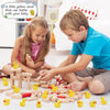 A boy and a girl are playing with mini yellow resin duck figurines for crafts and decor.