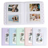 A white photo album with 64 pockets for instant cameras, featuring various photos.