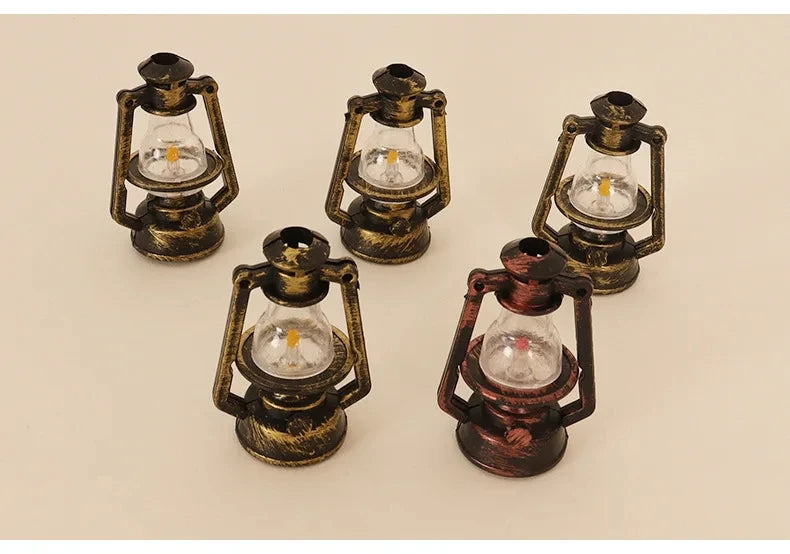 Four vintage ceramic miniature lanterns with glass bulbs and brass-colored metalwork for dollhouse décor