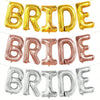 A set of foil balloons spelling the word BRIDE in gold, rose gold, and silver colors.