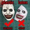 A white plastic latex mask resembling an exorcist demon face with exaggerated features.