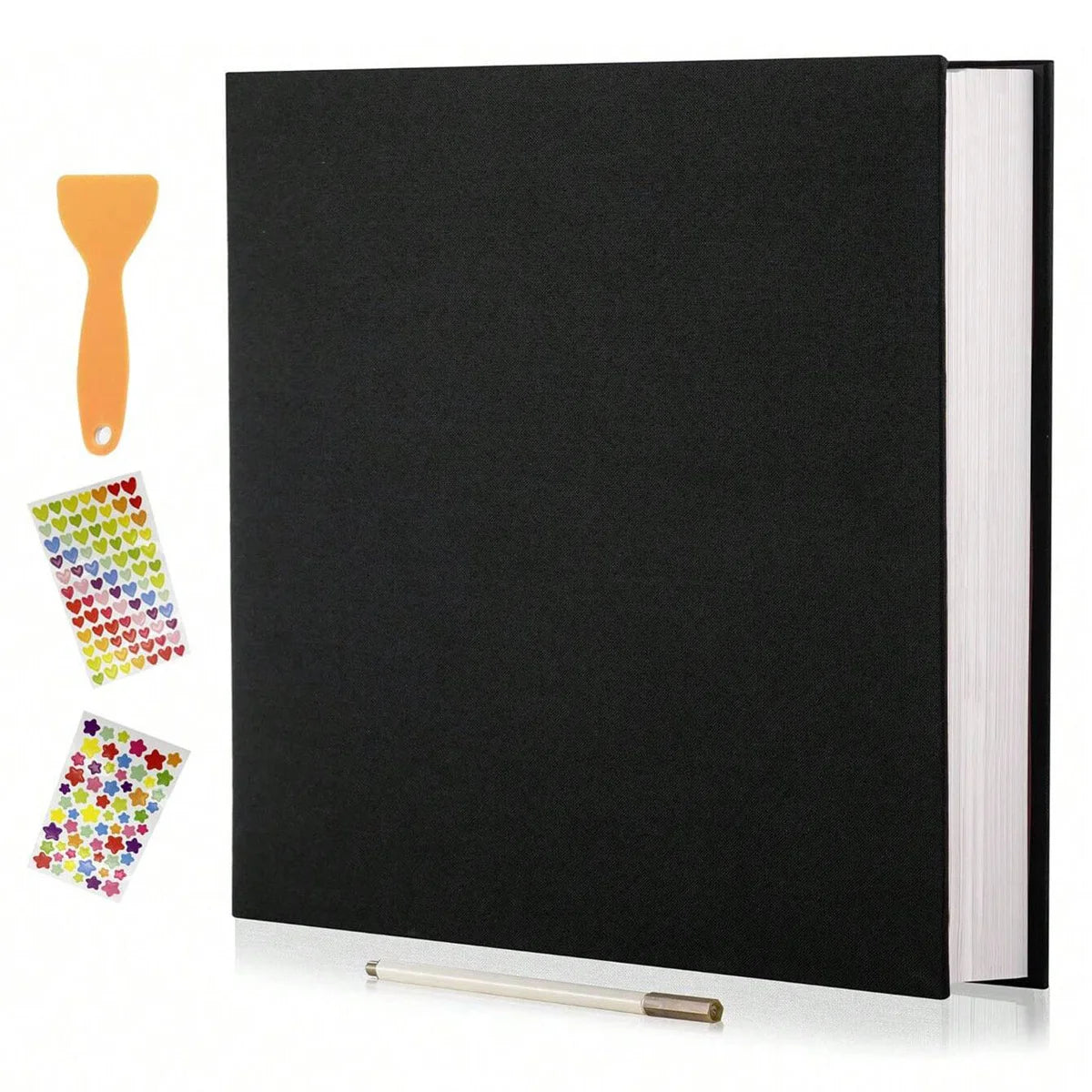 A black linen scrapbook photo album with a visible spine and an orange wooden tool lying next to it.