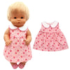 A blonde doll wearing a pink floral dress and a matching hat.