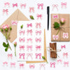 A set of pink and white decorative bow stickers for envelopes and rewards