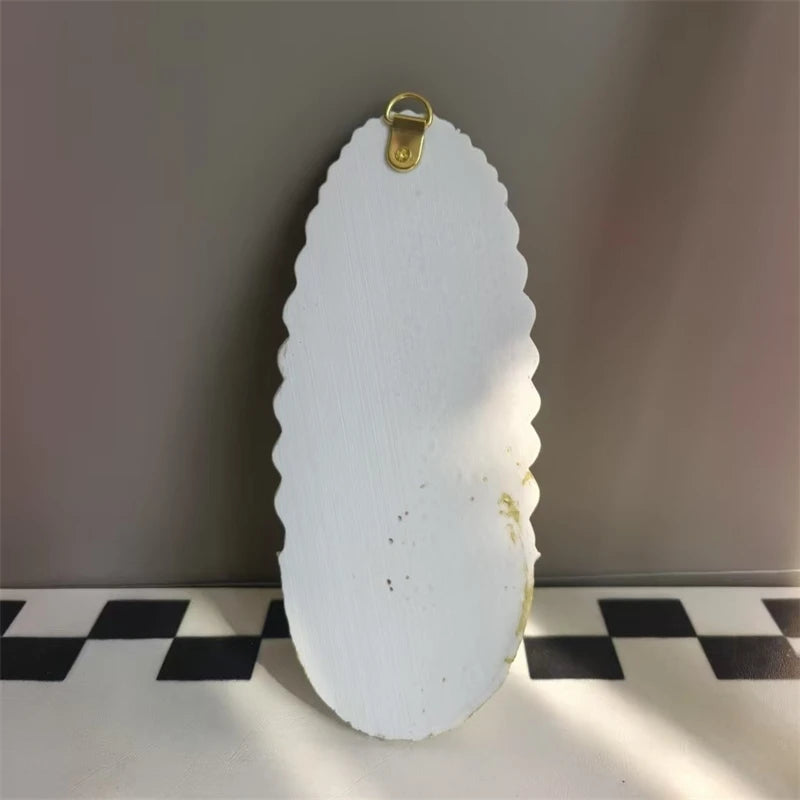 White resin virgin mary holy water wall decor with a gold hanging loop