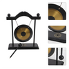 A black and brass gong decor set featuring a hanging gong, stand, and mallet.