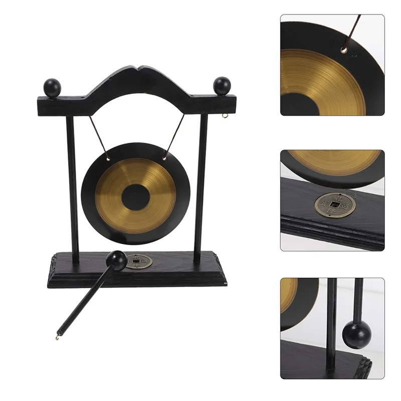 A black and brass gong decor set featuring a hanging gong, stand, and mallet.