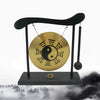A black desktop zen gong suspended by a cord, featuring a large golden yin-yang symbol.