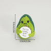 Handmade crochet potato doll with a green textured body and a white circular tag that reads You've totally guac this!