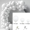 White balloon garland arch kit featuring round balloons and a white ribbon.