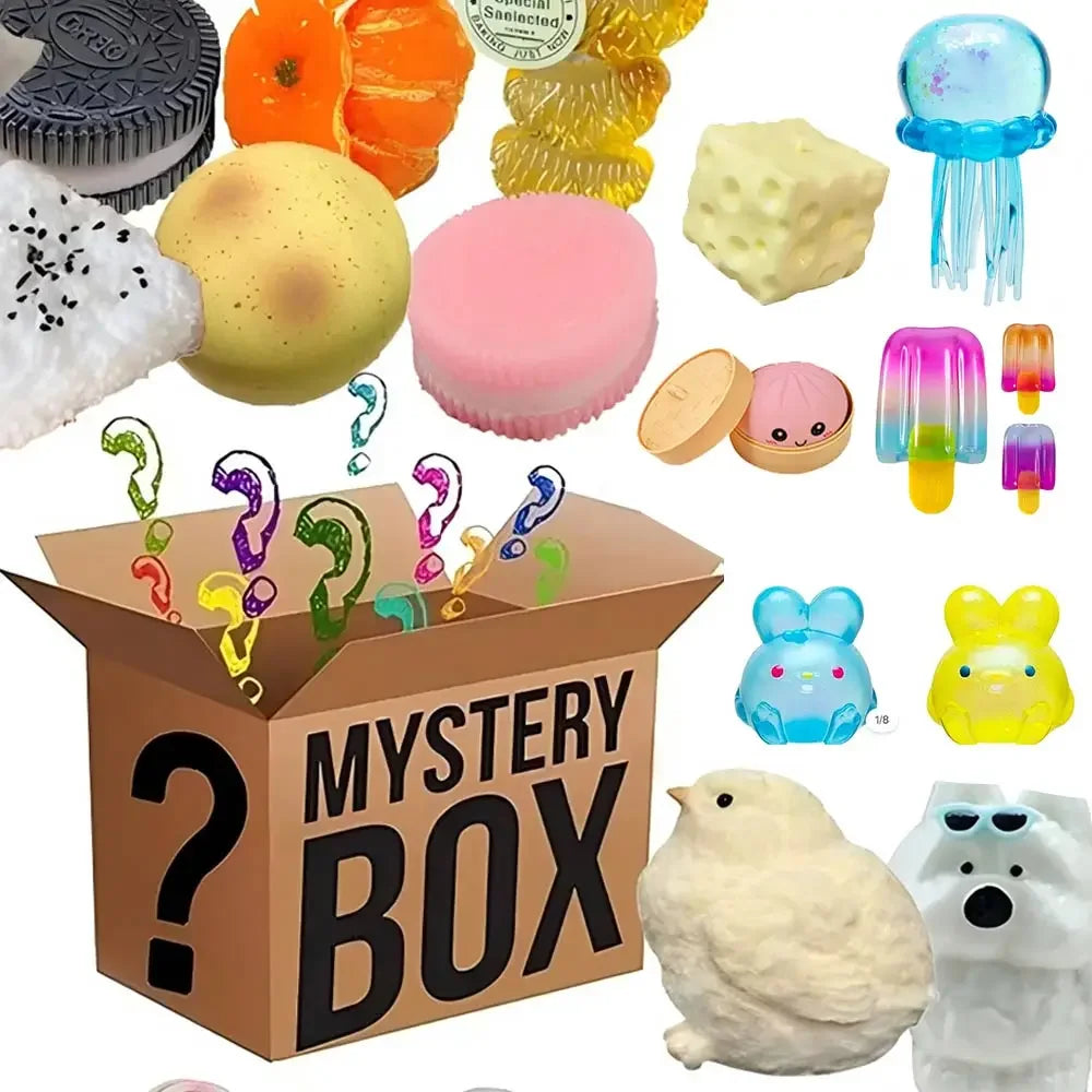 A box filled with various squishy toys including a yellow ball, pink foam, and small plastic items.