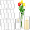 A set of nine clear glass cylinder vases for centerpieces and decor.
