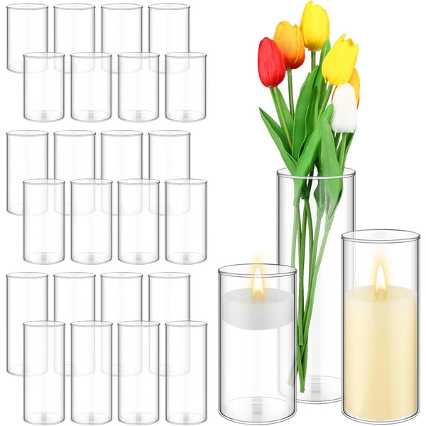 A set of nine clear glass cylinder vases for centerpieces and decor.