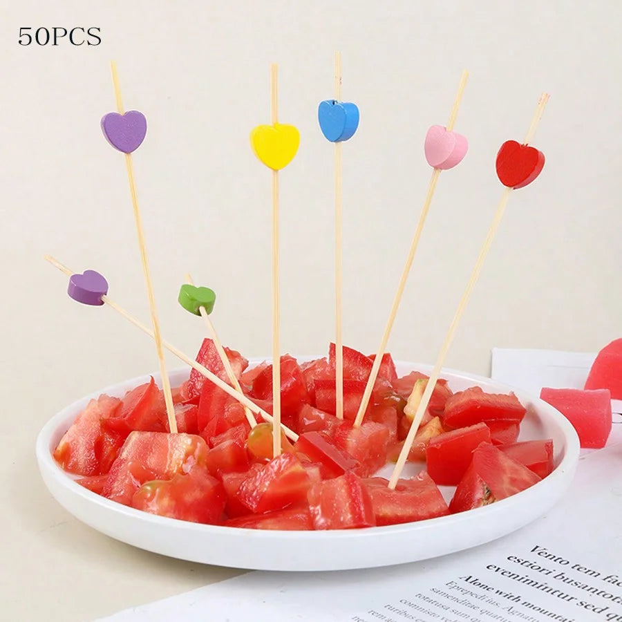 50 pieces of colorful bamboo fruit skewers arranged in a white bowl