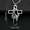 Silver pendant featuring a cross design with praying hands carved into the center.