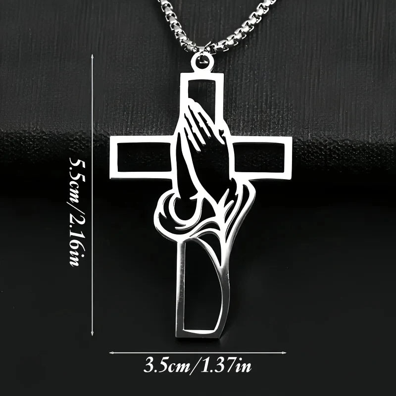 Silver pendant featuring a cross design with praying hands carved into the center.