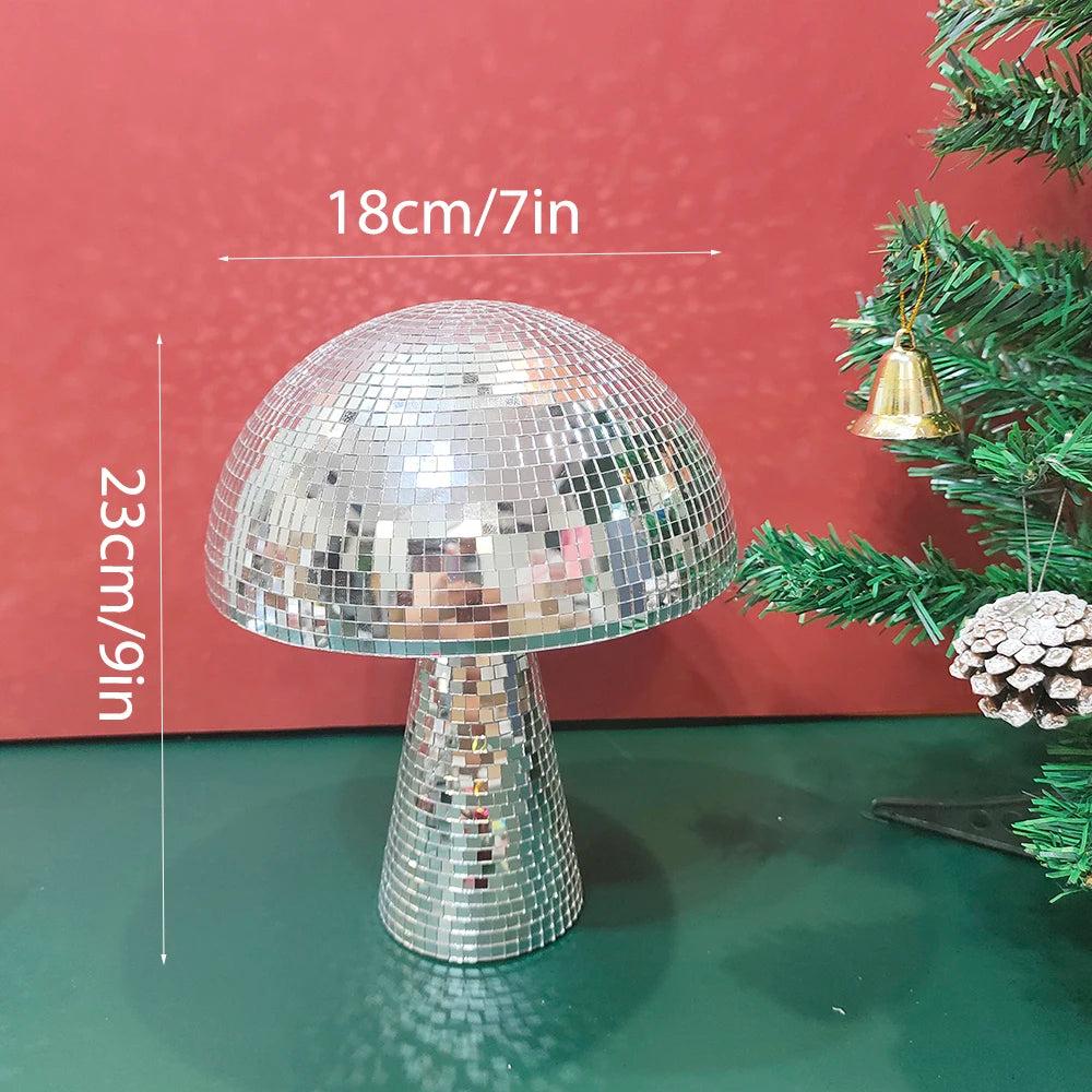 Silver mushroom-shaped disco ball decoration with a textured base displayed against a red background.