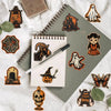 A collection of dark orange and black retro graffiti aesthetic stickers on a gray notebook and white fabric.