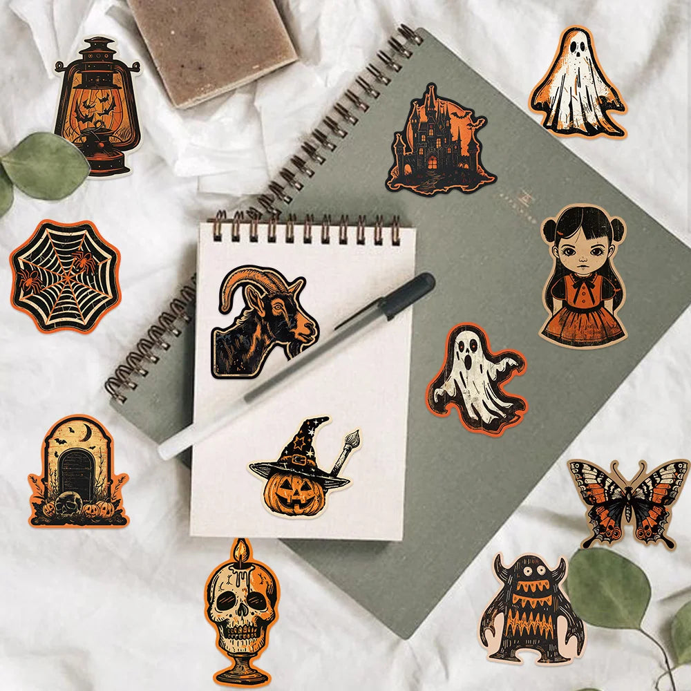 A collection of dark orange and black retro graffiti aesthetic stickers on a gray notebook and white fabric.