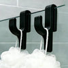 Black 3D shower door towel hooks hanging from a glass rod above a white towel