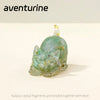 A translucent green crystal cat statue made from natural crystal fragments bonded with resin.