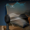 A black portable rechargeable handheld fan is shown next to a sheet of paper, illustrating its low decibel noise level.