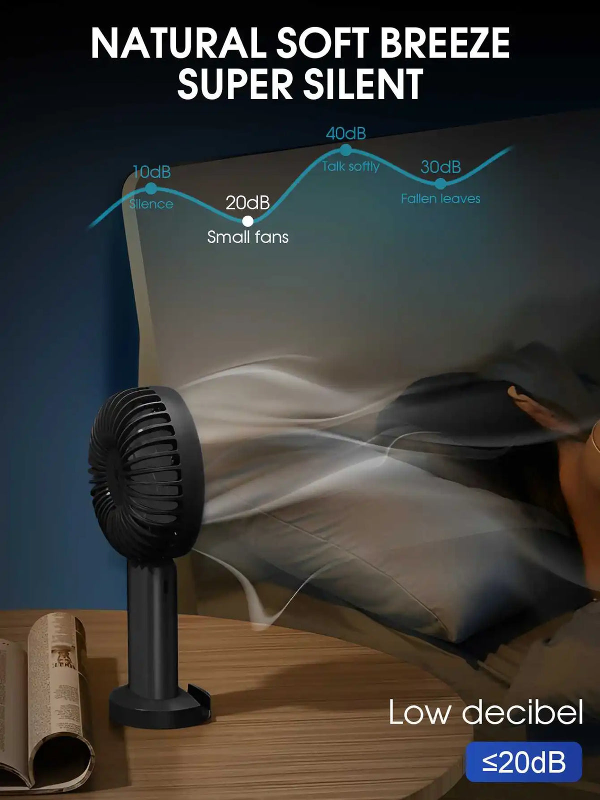 A black portable rechargeable handheld fan is shown next to a sheet of paper, illustrating its low decibel noise level.